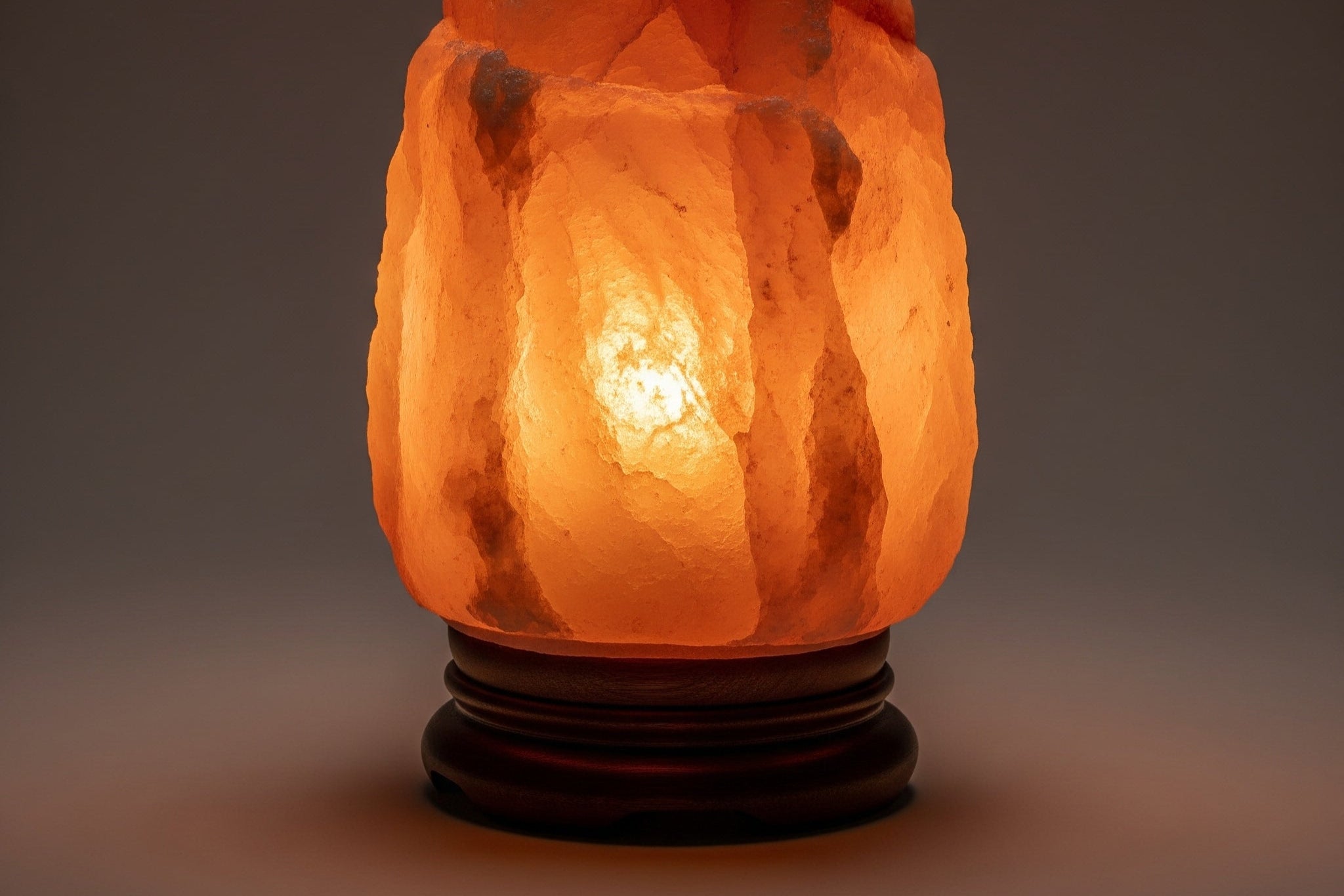 Decorative salt lamp with a warm glow on a dark background